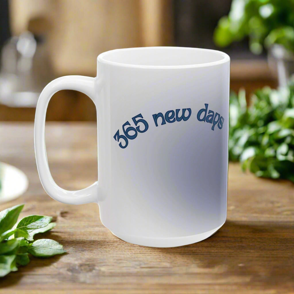 A white ceramic coffee mug with the inspirational quote '365 new days' printed in blue.