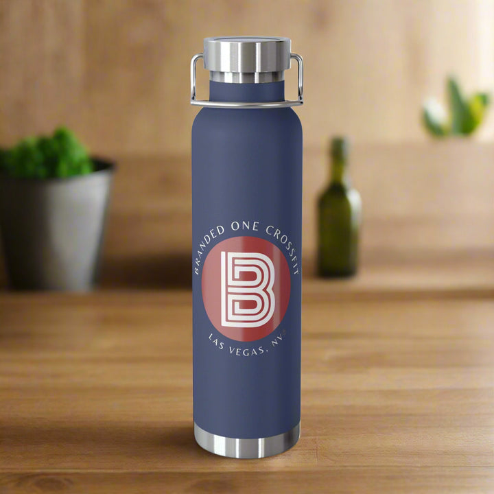 A navy blue copper vacuum insulated bottle with a white and red Branded one Crossfit logo