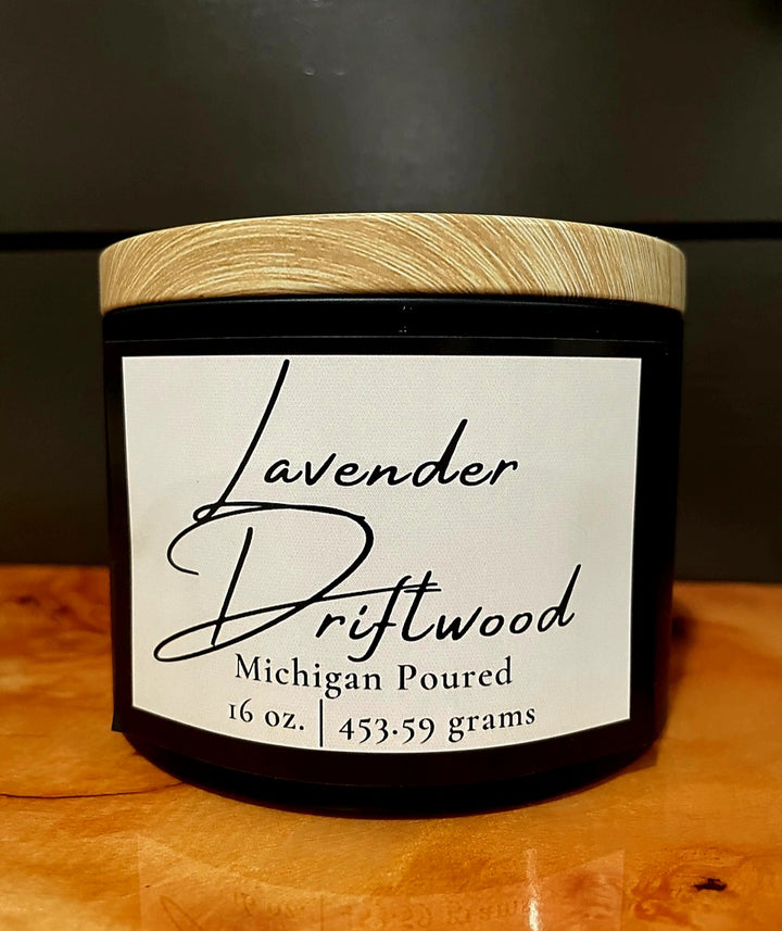 Lavender Driftwood 16 oz soy candle in black jar with wooden lid, Michigan poured, minimalist white label design, hand-poured aromatherapy candle with warm smoky fragrance, rustic home décor and gift idea.
