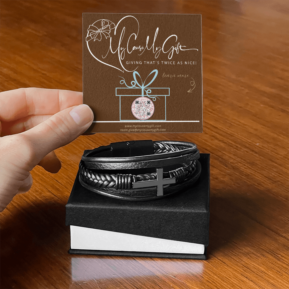 Leather braided bracelet with a stainless steel cross on a wooden surface