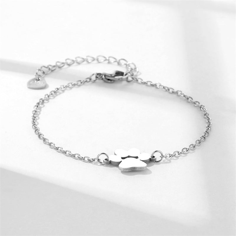 Delicate silver chain bracelet with paw print charm, adjustable clasp with heart detail, minimalist pet lover jewelry and meaningful gift