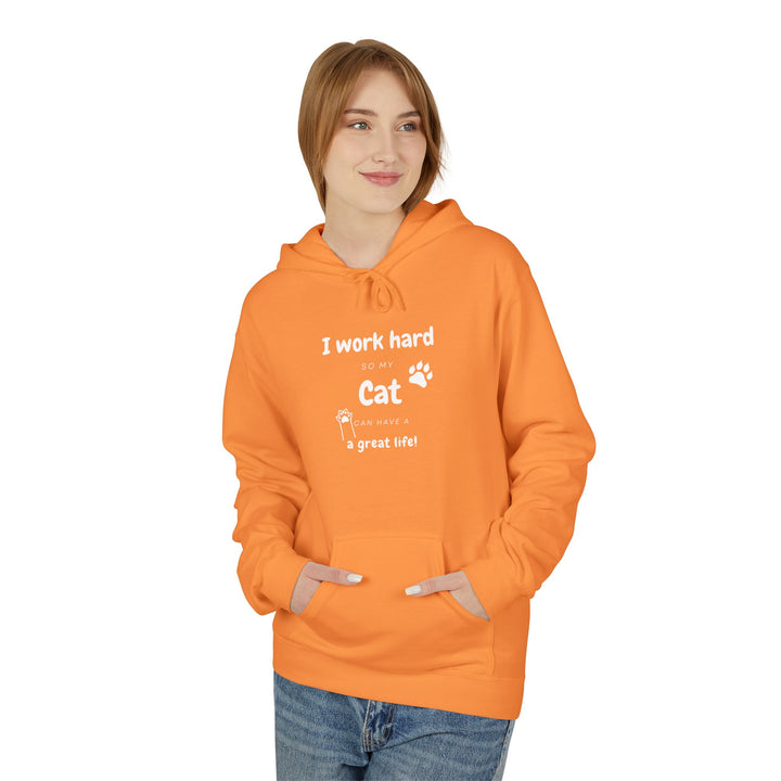 Woman wearing orange hoodie with text “I work hard so my cat can have a great life,” featuring cat paw print — cozy cat lover gift sweatshirt.