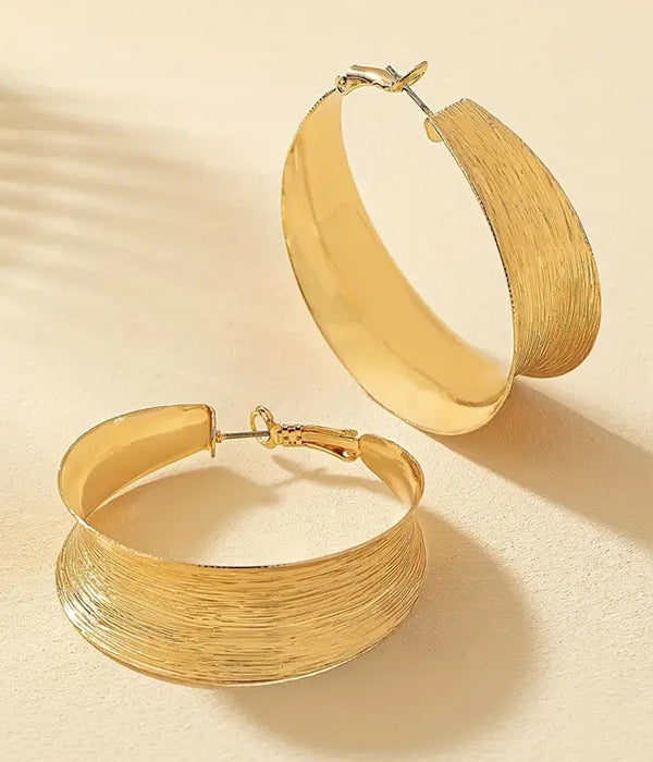 Two thicker golden hoop earrings