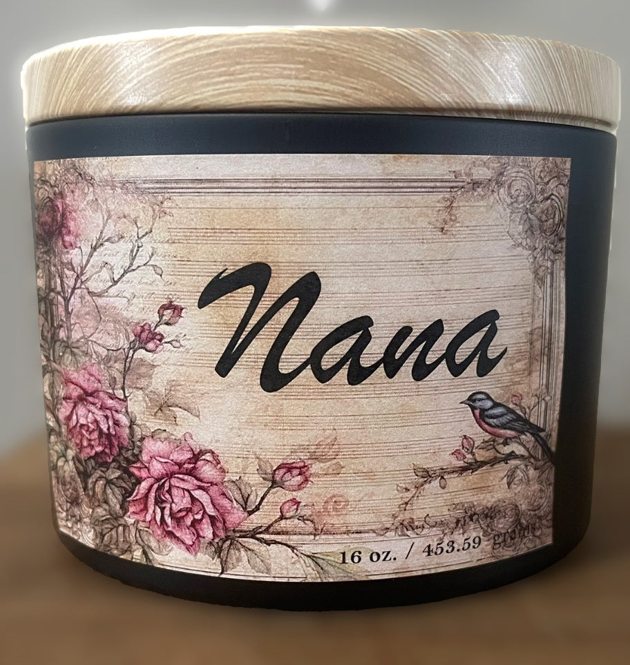 Nana 16 oz soy candle in black jar with wooden lid, vintage floral label design featuring pink roses and small bird illustration, decorative aromatherapy candle and gift