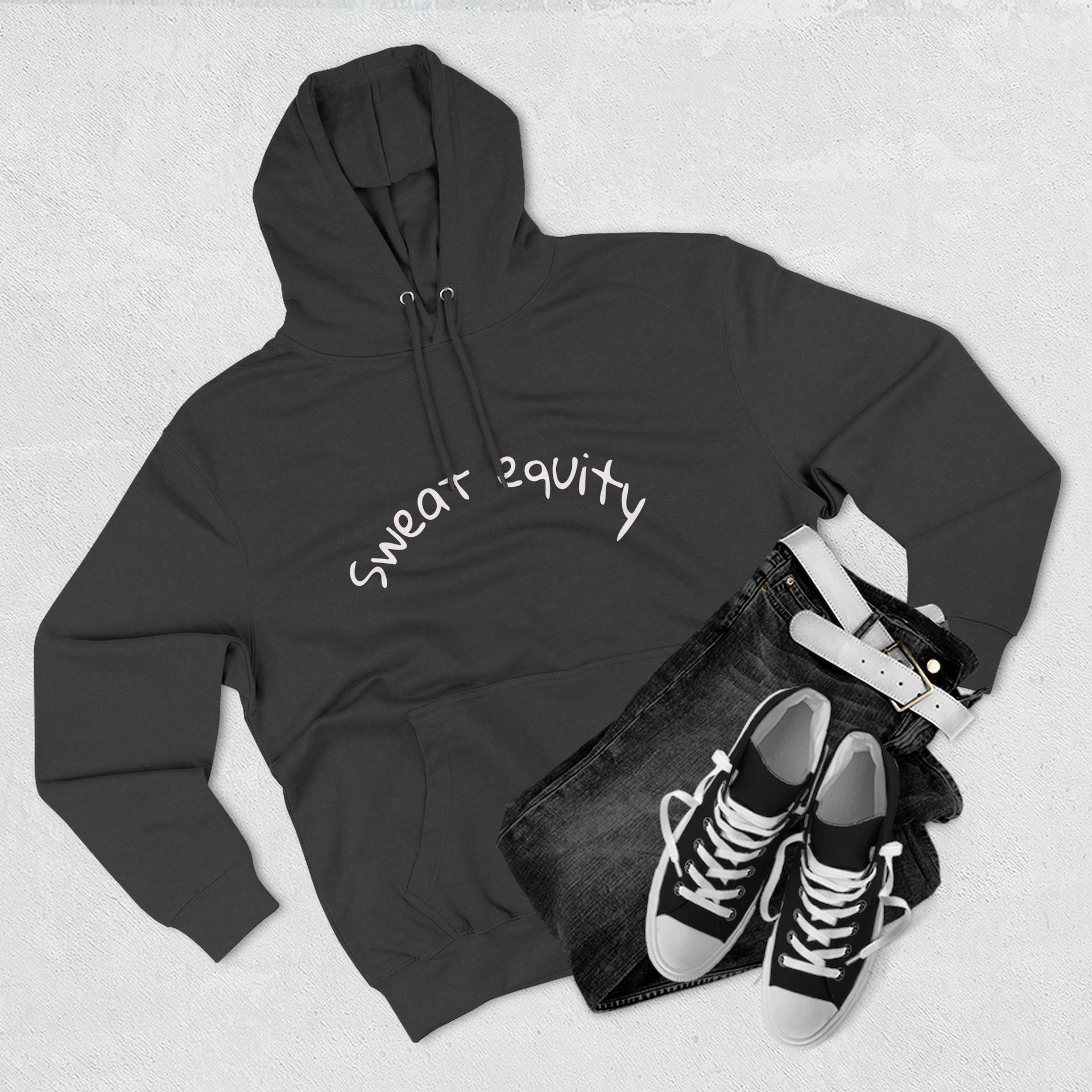 Black “Sweat Equity” hoodie displayed flat with black jeans, belt, and sneakers, modern unisex fitness and motivation sweatshirt for gym lovers and entrepreneurs.
