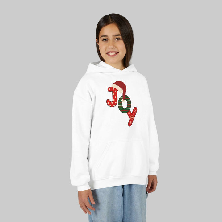 Young girl wearing a white hoodie with 'JOY' printed on it against a gray background