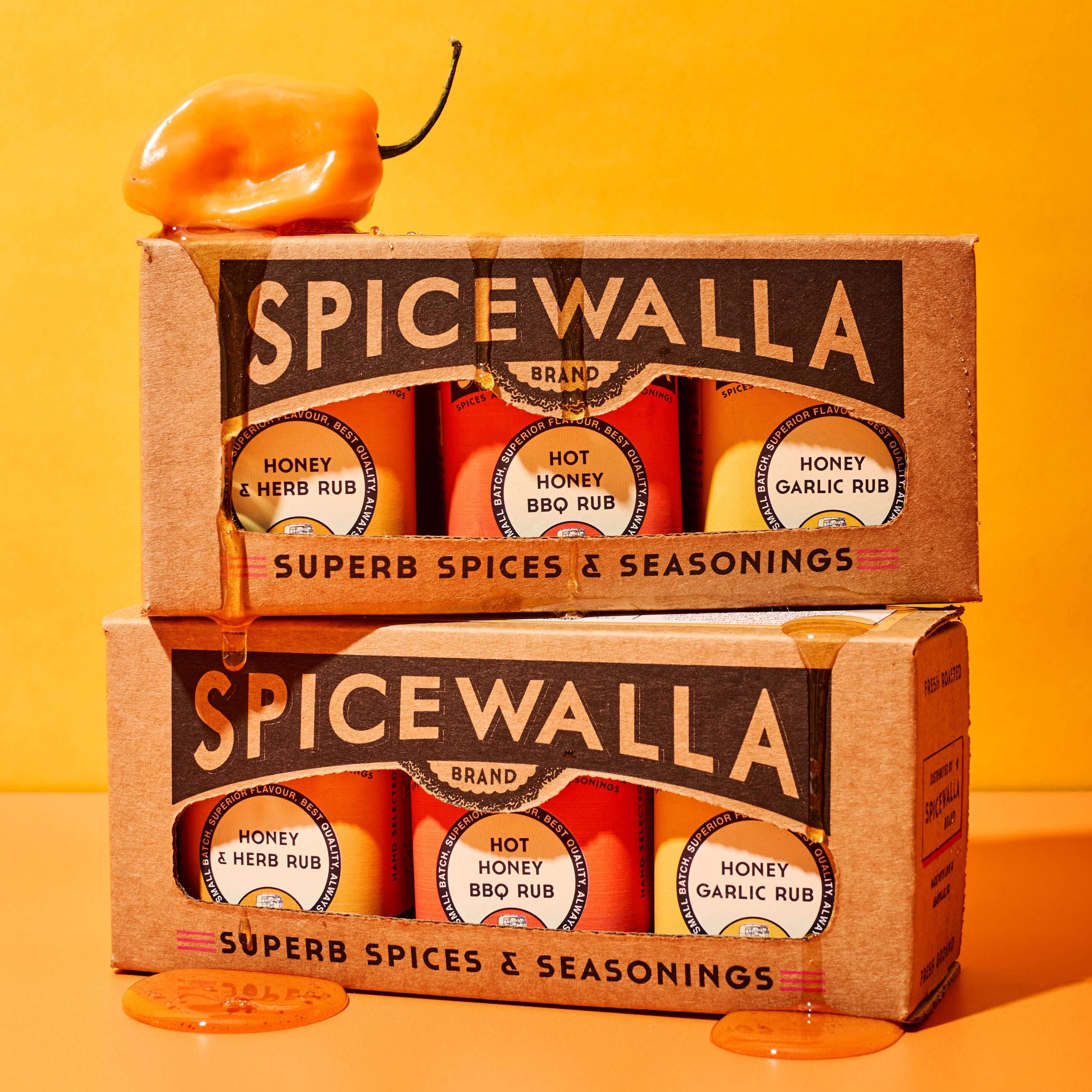 3 pack honey collection gourmet gift set with sweet and spicy honey blends in boxed presentation on bright orange background