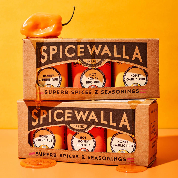 3 pack honey collection gourmet gift set with sweet and spicy honey blends in boxed presentation on bright orange background