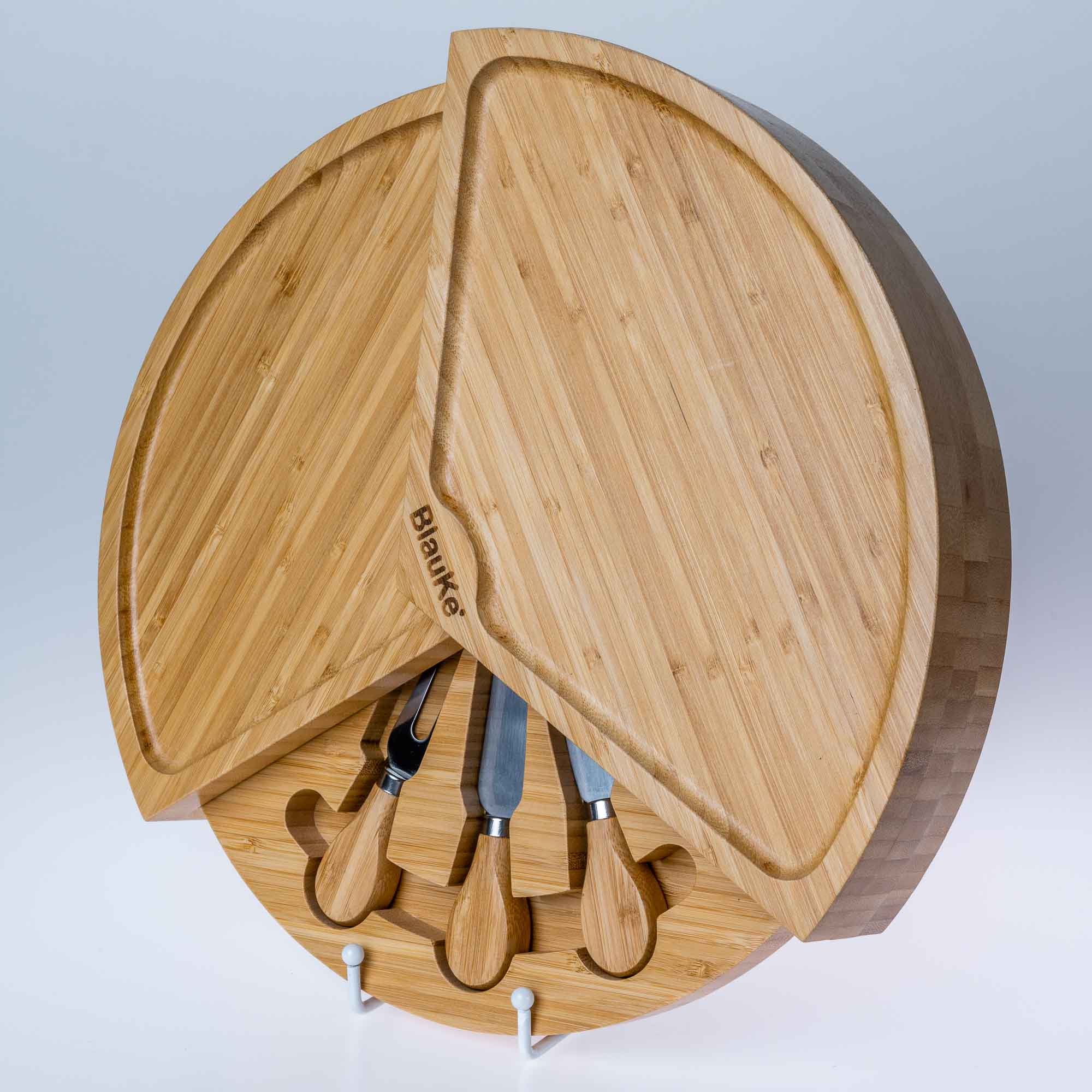 Wooden cutting board with knives on a light gray background