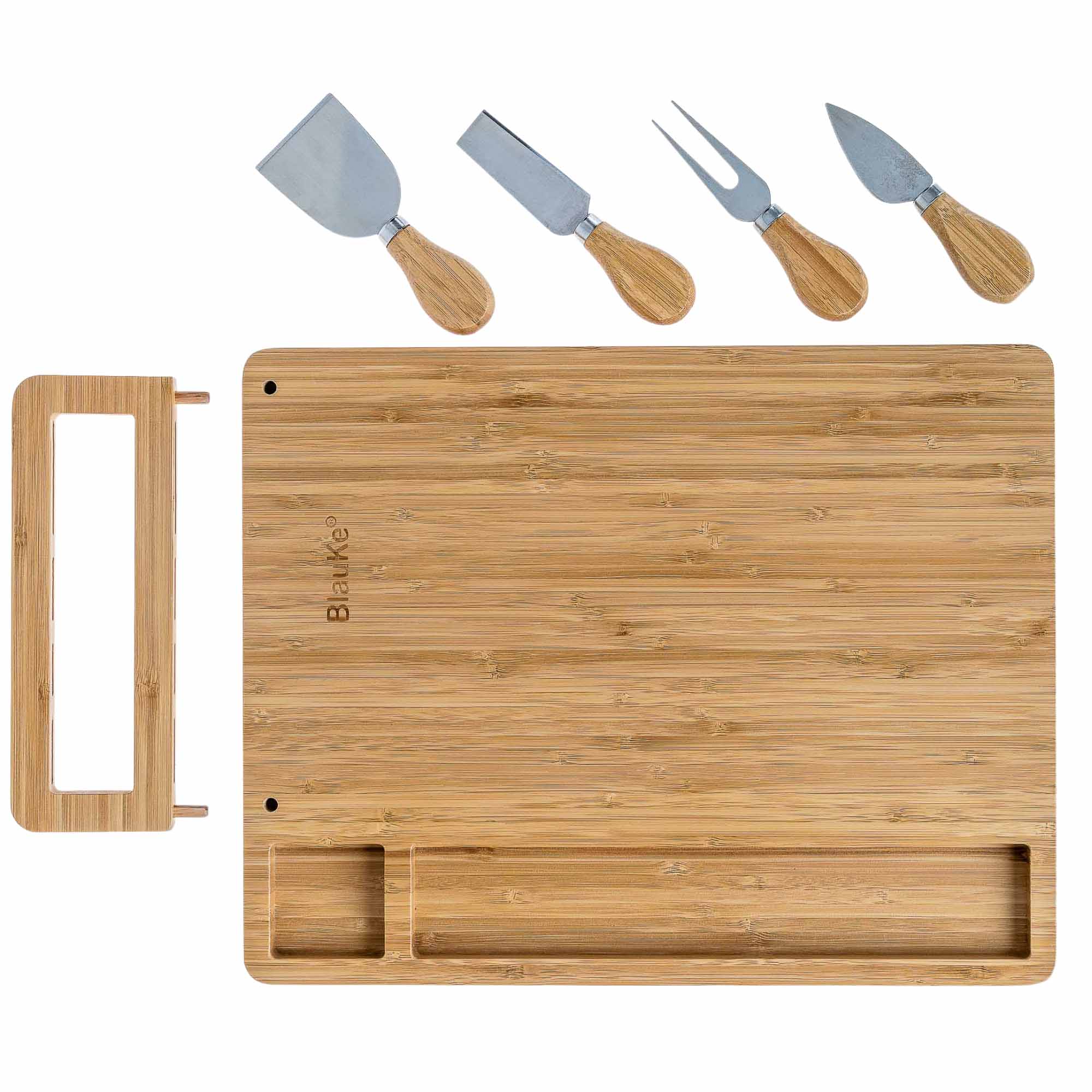Bamboo cutting board with cheese tools on a white background