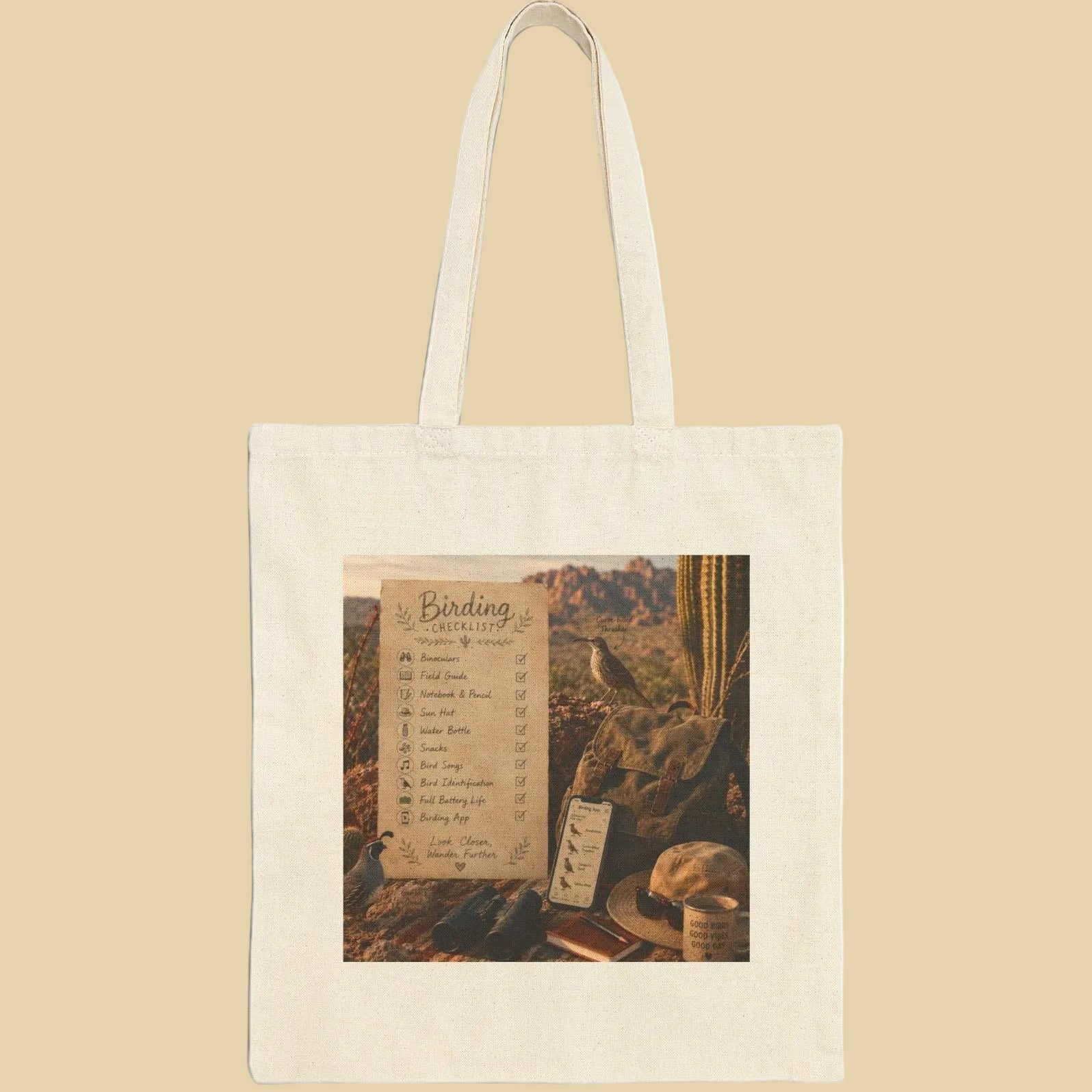 Birding checklist tote bag desert with checklist, set against a desert backdrop, perfect for birdwatching adventures.