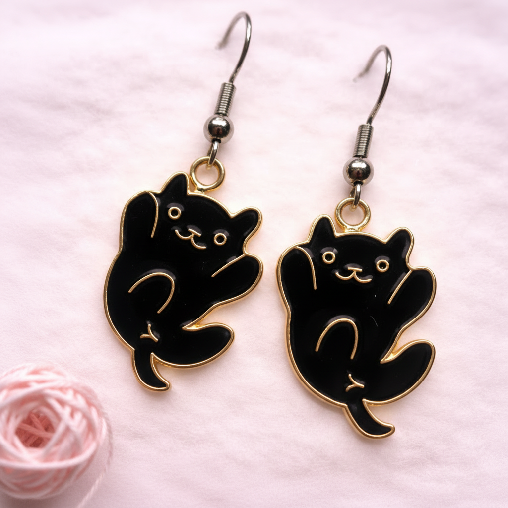 Black cat dangle earrings with gold accents, playful cat design, hypoallergenic jewelry by Sonya Lee.