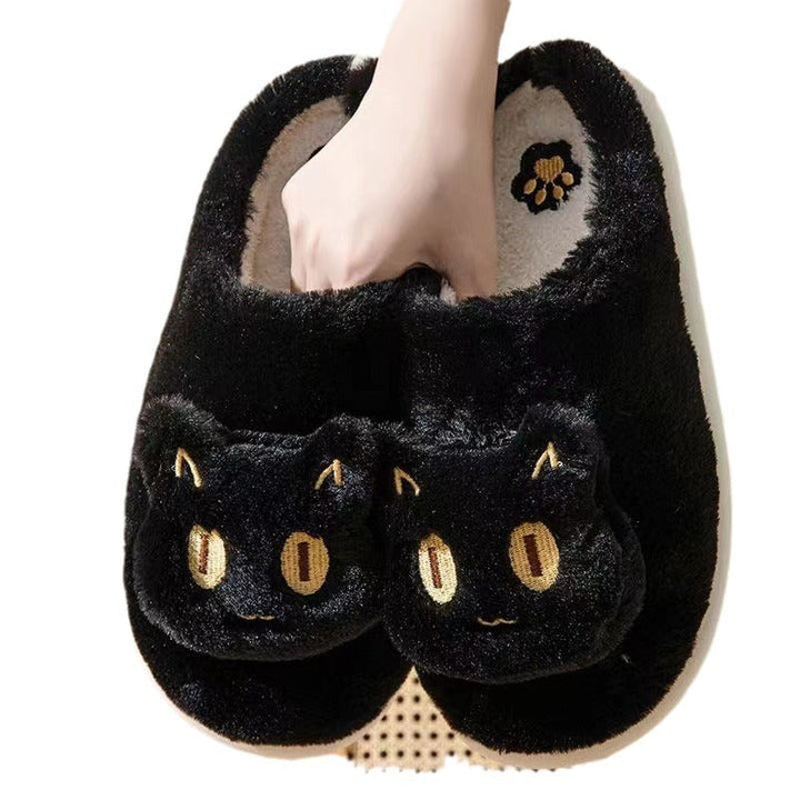Black plush cat slippers with embroidered eyes and soft soles
