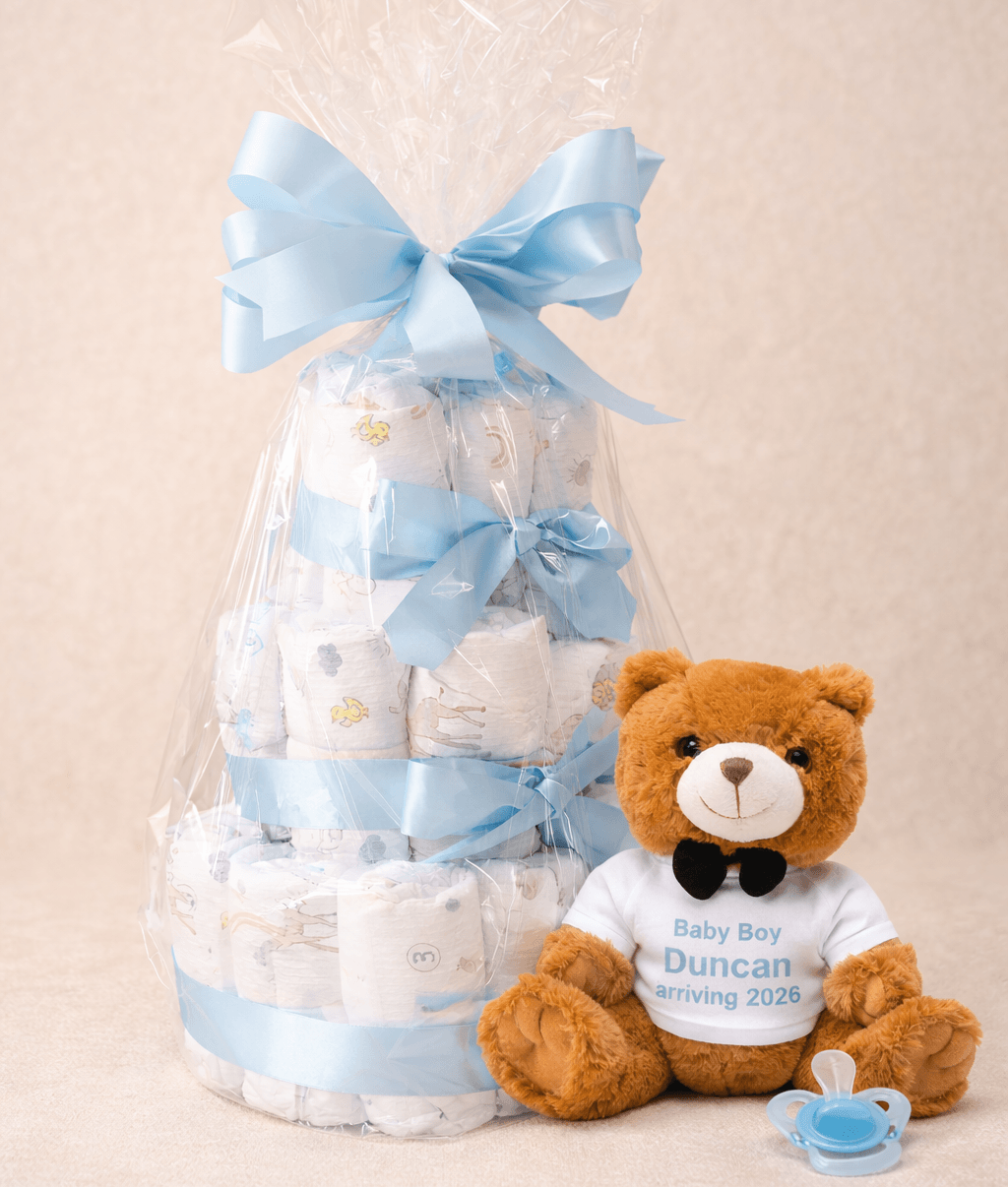 Baby shower gift set with diaper cake and teddy bear on a beige background