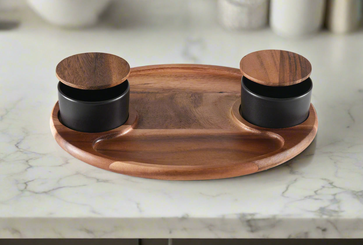 Wooden tray with two black containers on a white background