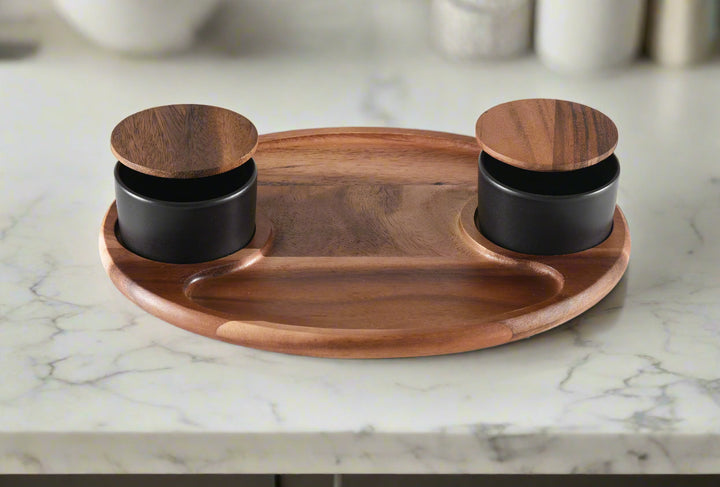 Wooden tray with two black containers on a white background