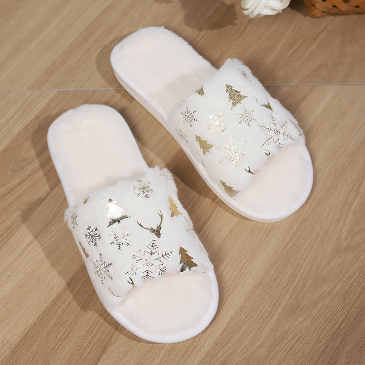 White slippers with Christmas designs on a wooden floor
