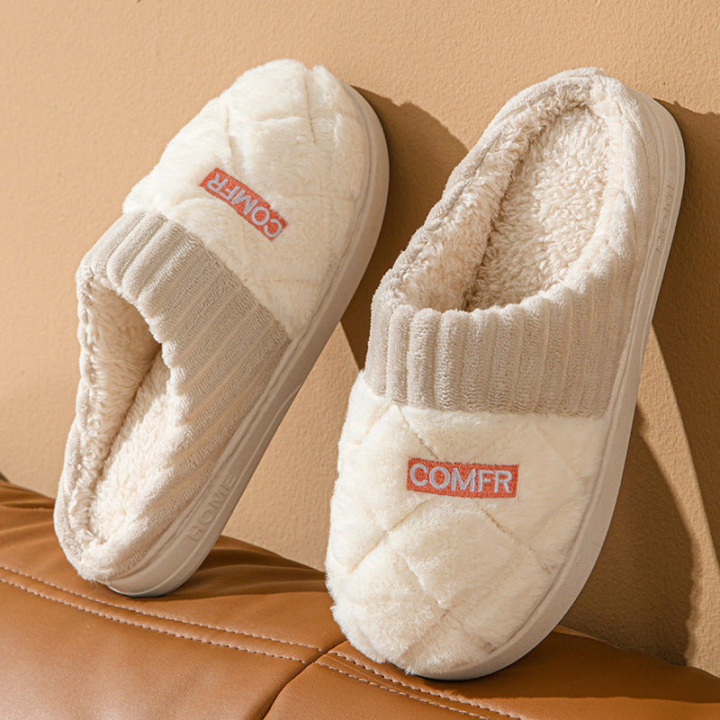 Pair of white slippers with 'COMFR' branding on a brown surface