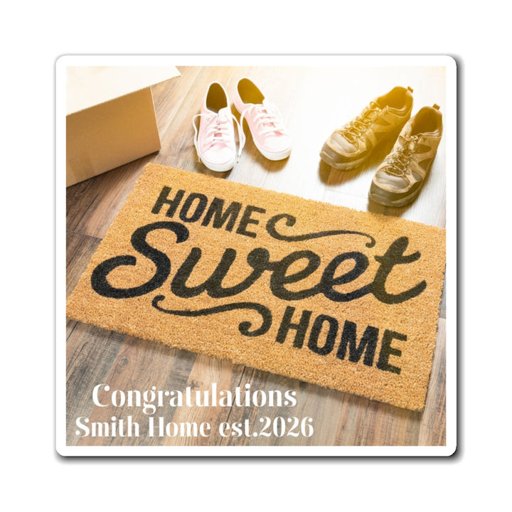 Customized Magnet of a doormat with 'Home Sweet Home' text on a wooden floor with shoes and a box.
