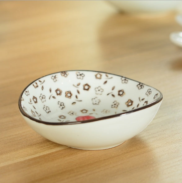 Decorative ceramic bowl with floral patterns on a wooden surface