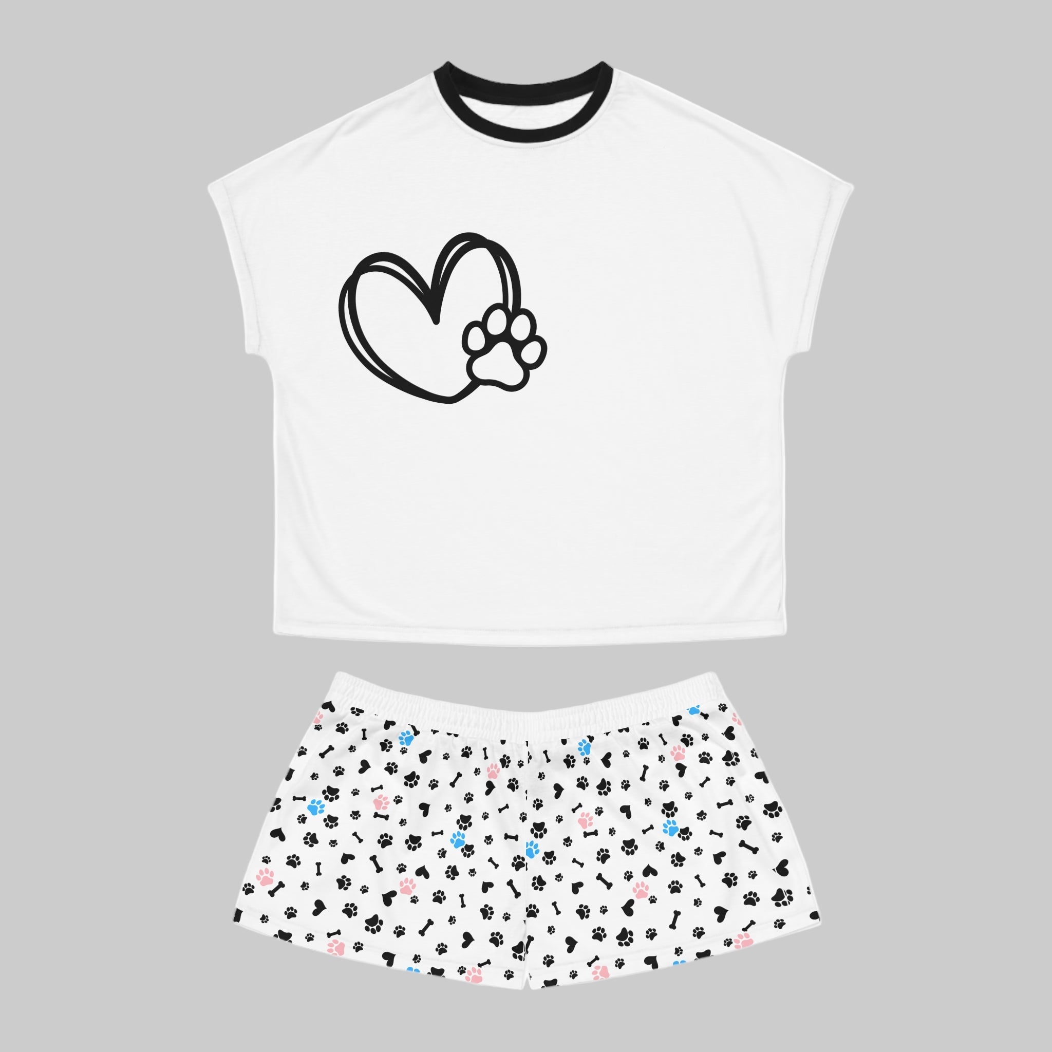 White crop top with black heart and paw print design, paired with a skirt featuring multicolored paw prints on a white background.