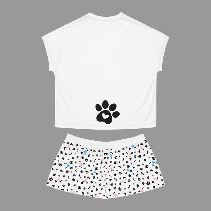 White sleeveless top with black paw print design and patterned shorts on a white background