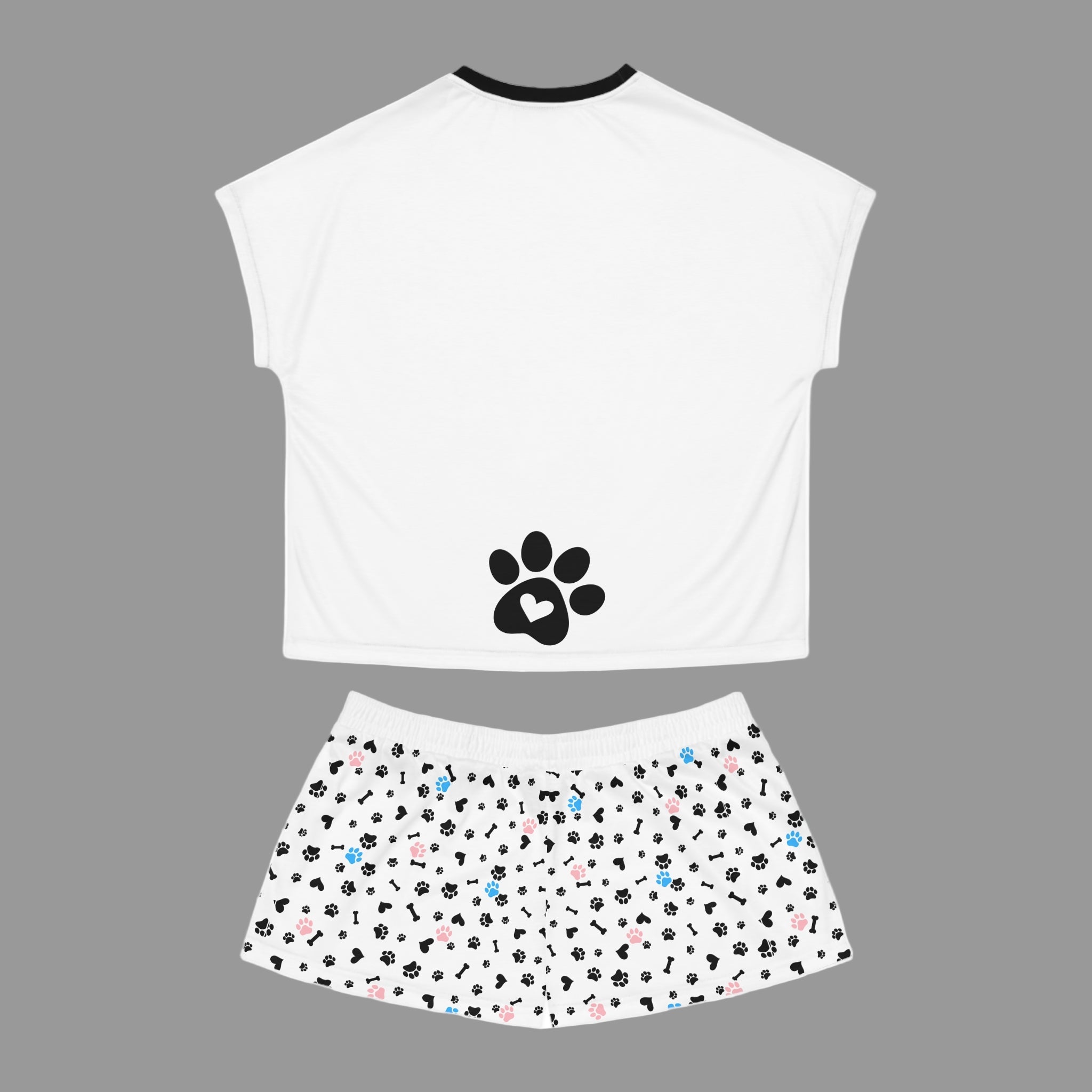 White sleeveless top with a black paw print design and patterned shorts on a white background