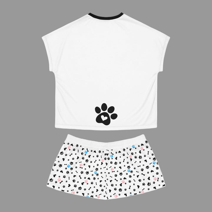 White sleeveless top with a black paw print design and patterned shorts on a white background