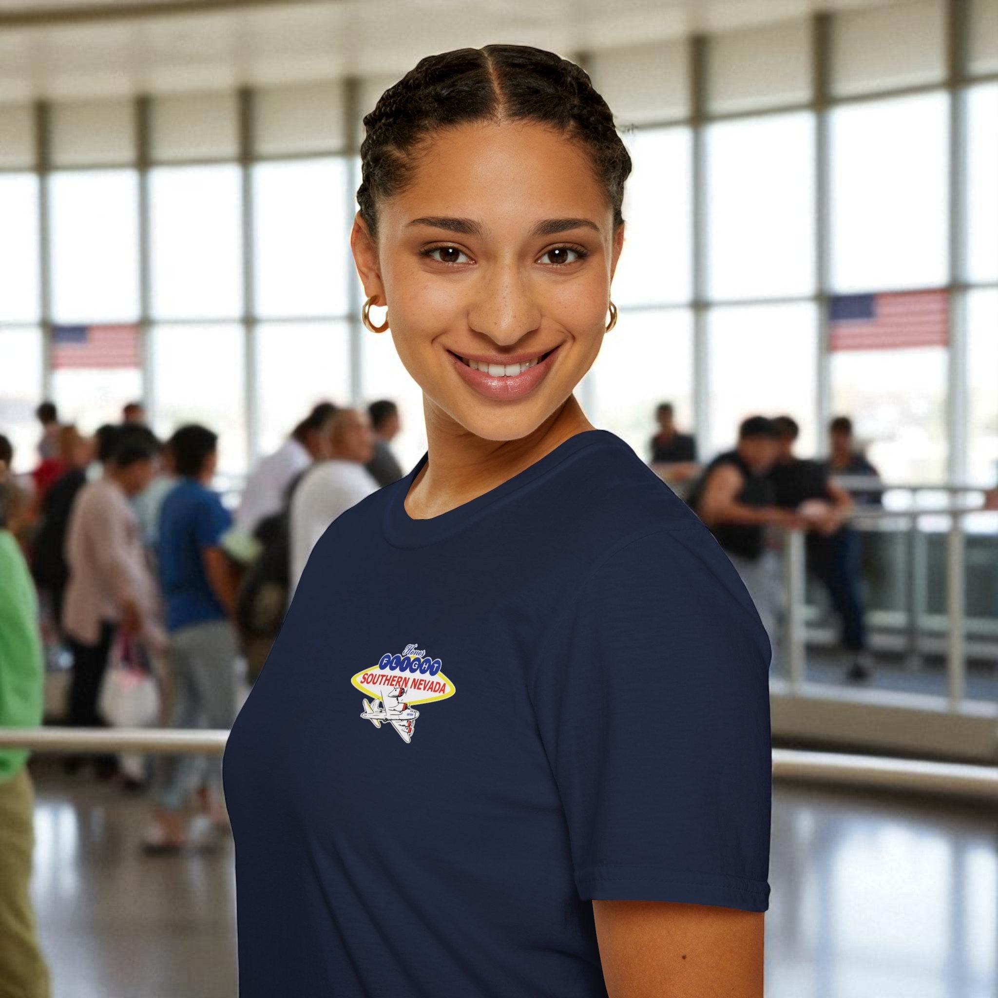 Woman wearing a navy blue t-shirt with a logo in an indoor setting