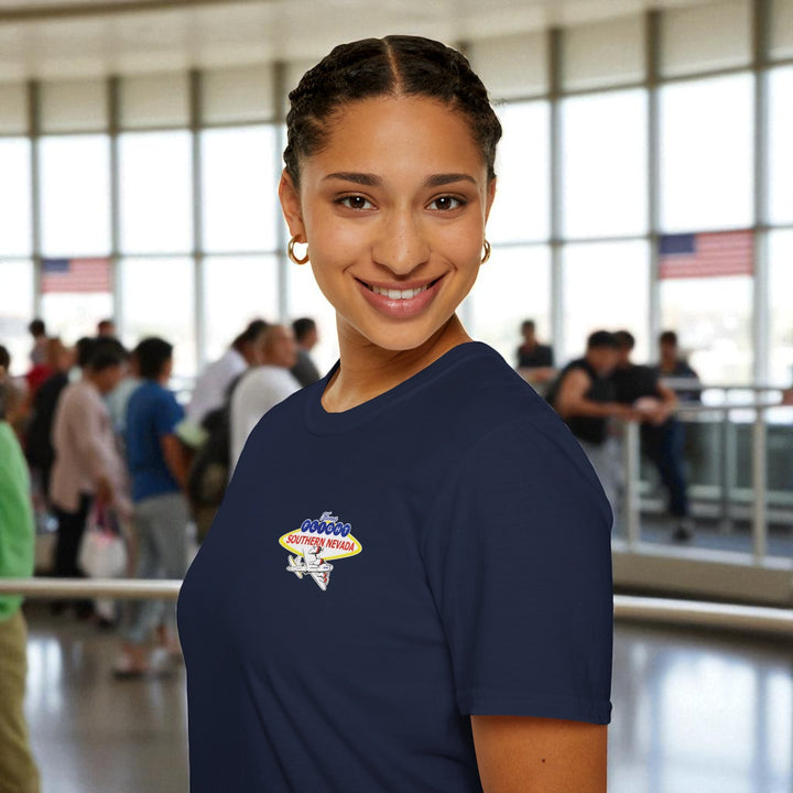 Woman wearing a navy blue t-shirt with a logo in an indoor setting
