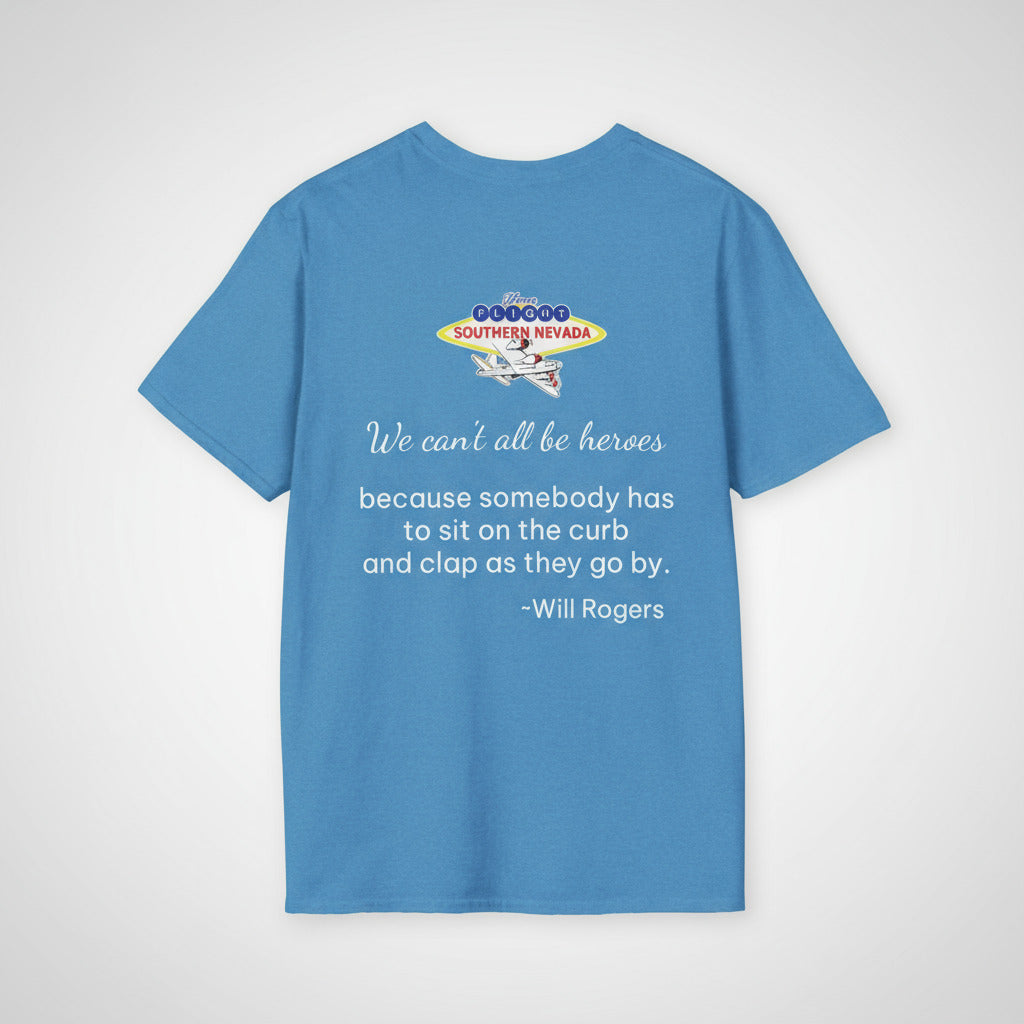 Honor Flight Southern Nevada blue unisex t-shirt with quote by Will Rogers that reads “We can’t all be heroes because somebody has to sit on the curb and clap as they go by,” patriotic apparel supporting veterans and their guardians.