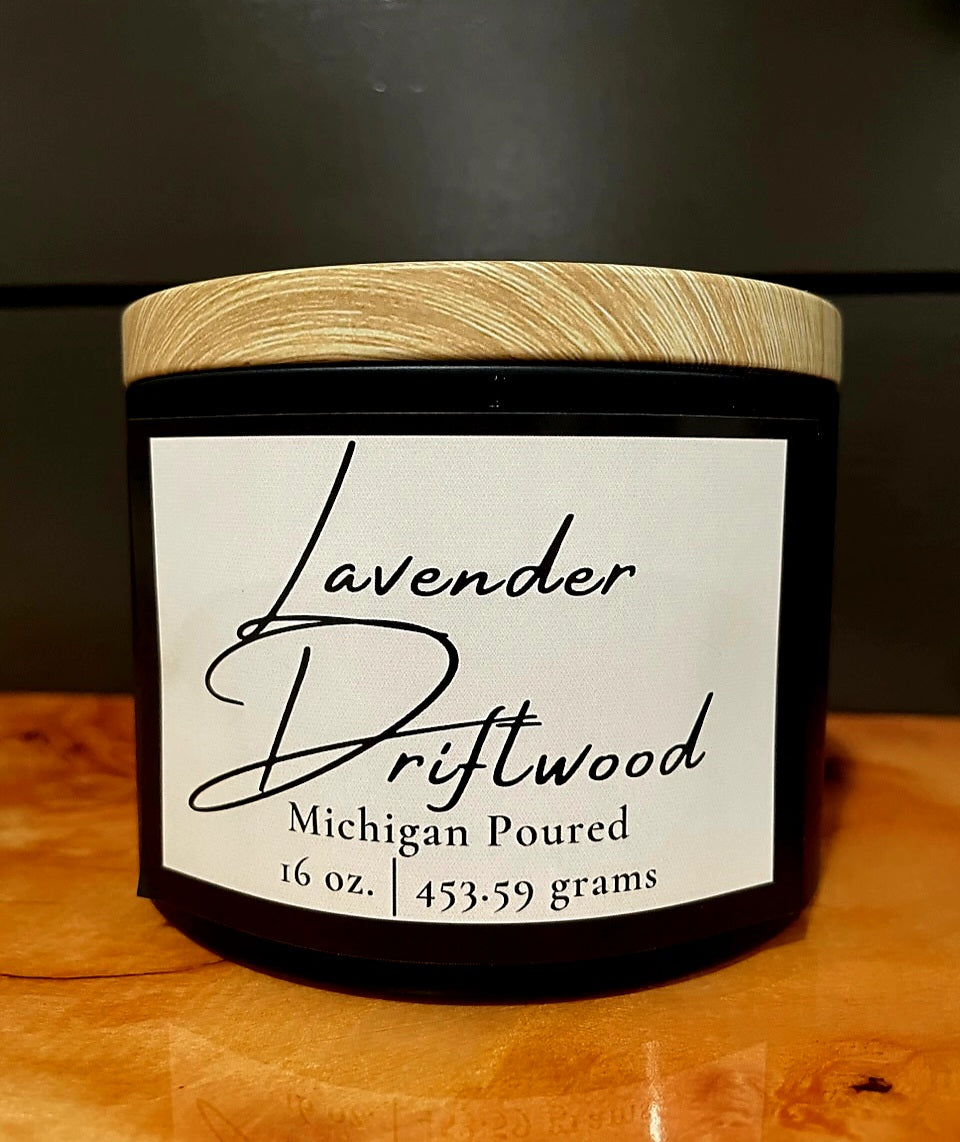Lavender Driftwood 16 oz soy candle in black jar with wooden lid, Michigan poured, minimalist white label design, hand-poured aromatherapy candle with warm smoky fragrance, rustic home décor and gift idea.