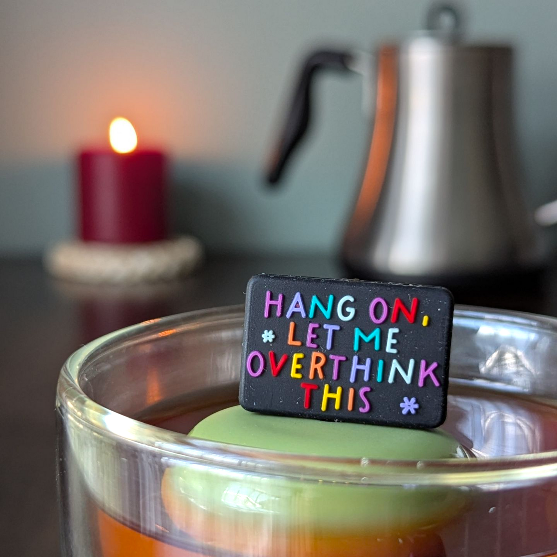 Cute loose leaf tea infuser with the phrase 'Hang On, Let Me Overthink This' in a glass of tea.
