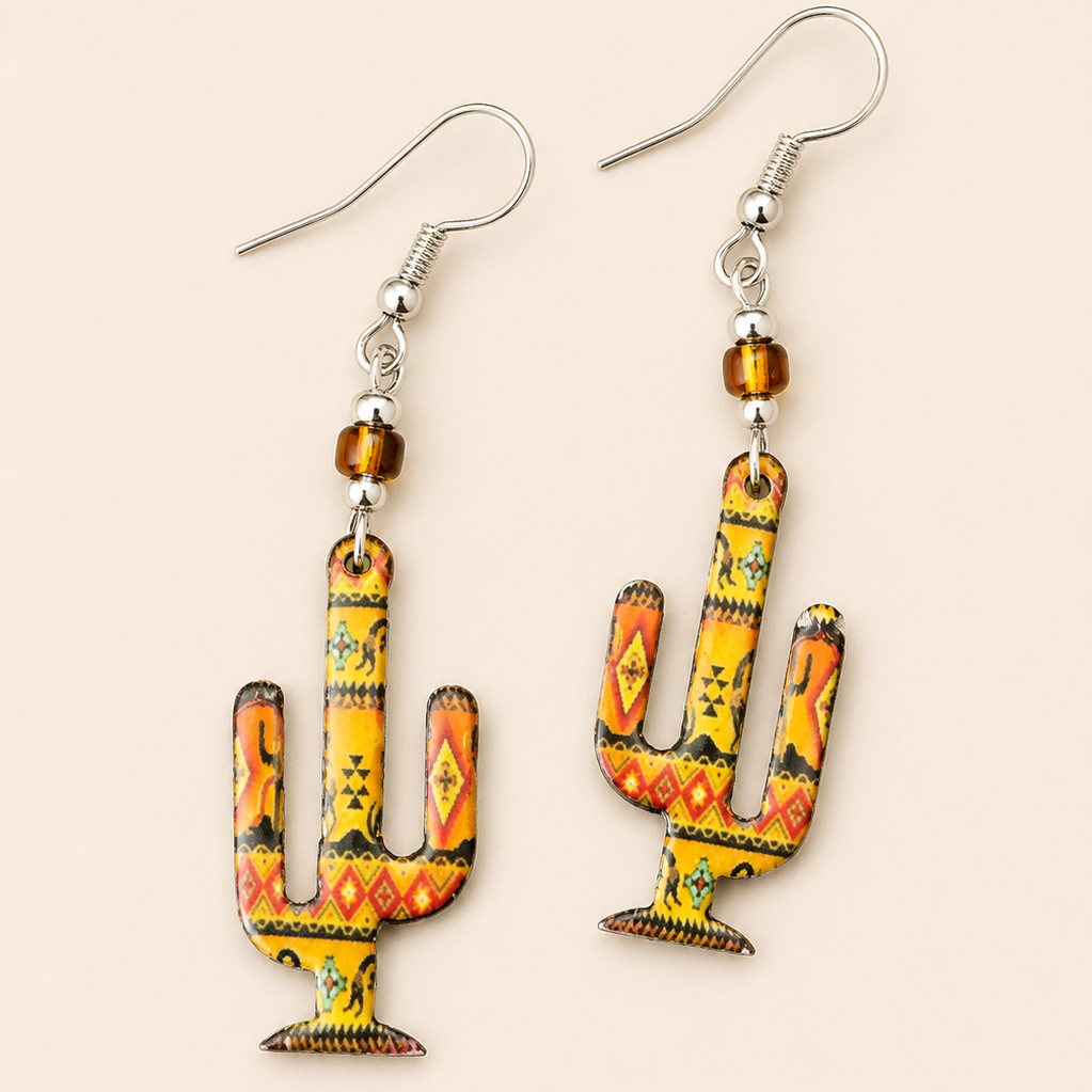 Colorful Southwestern cactus dangle earrings featuring desert-inspired patterns and amber bead accents on a soft cream background.