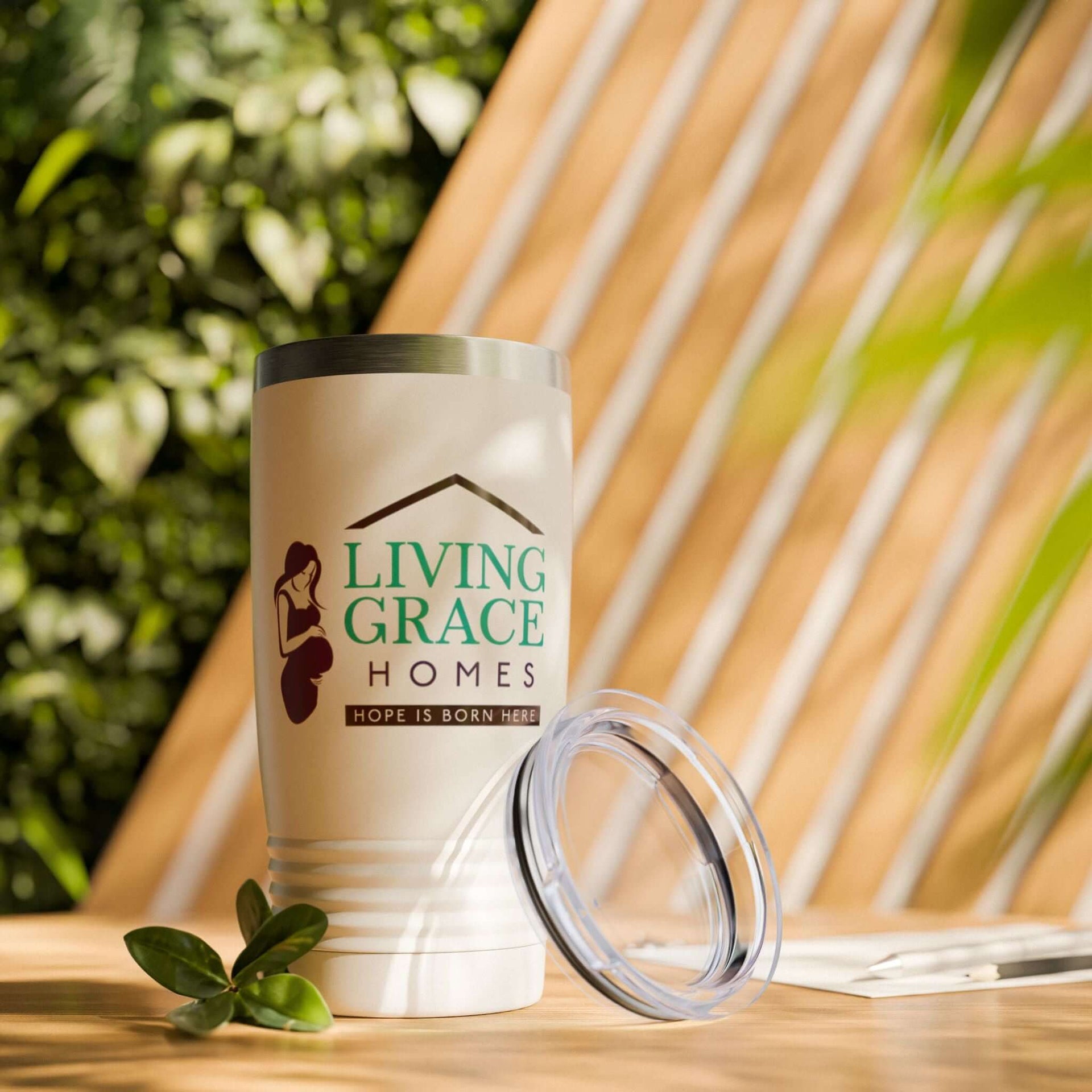 20oz Living Grace Homes stainless steel insulated travel mug with lid, designed for durability and style.