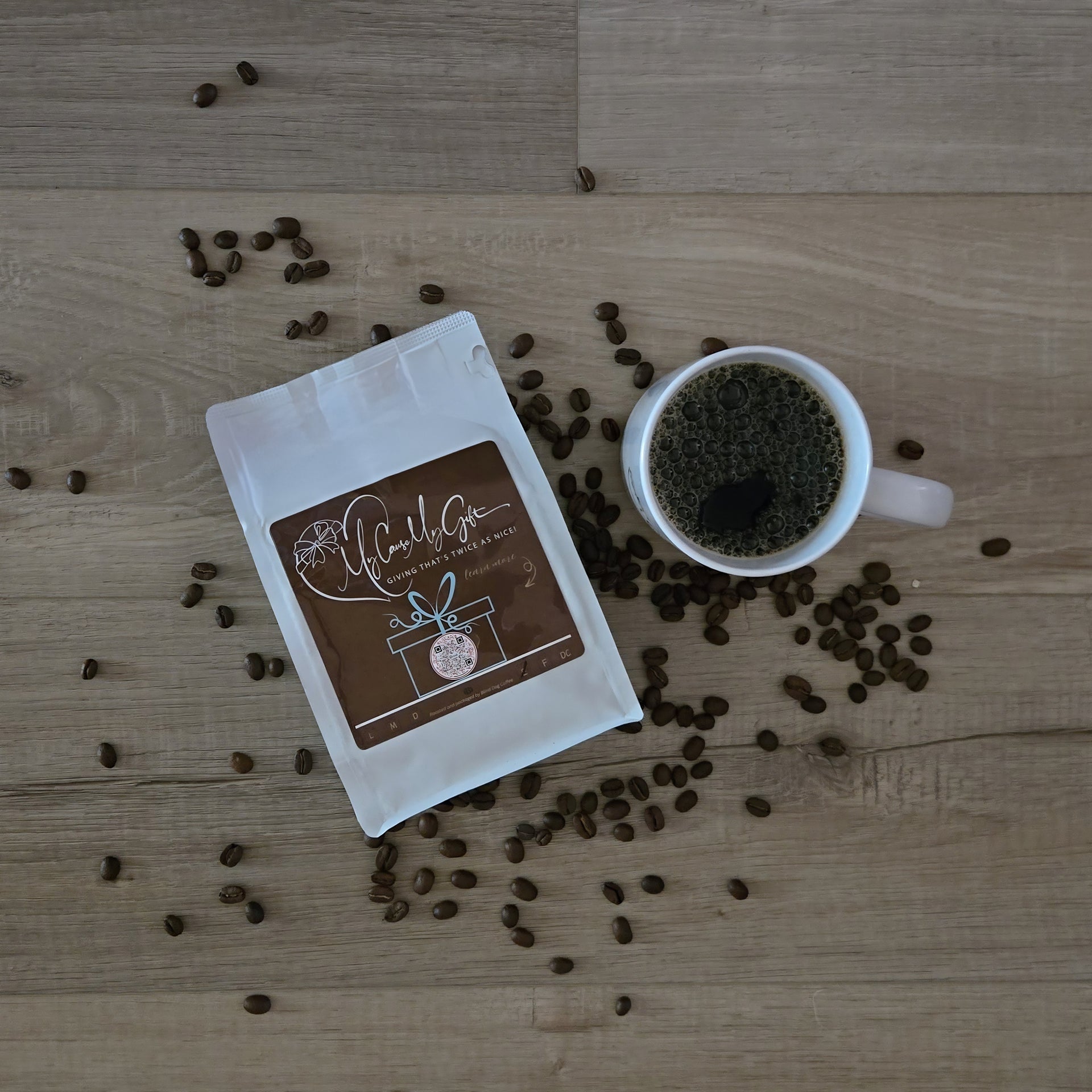 Coffee bag and cup with scattered coffee beans on a wooden surface
