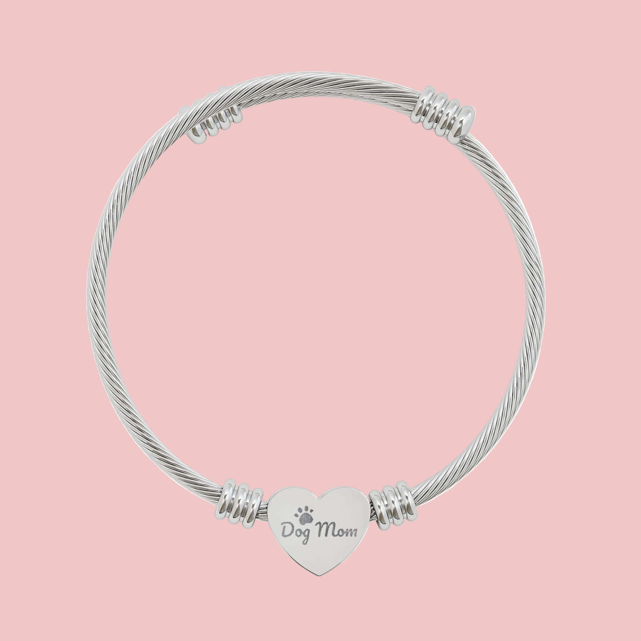 Engravable heart cuff bracelet featuring a charm that says 'Dog Mom' on a sleek cable wire design.