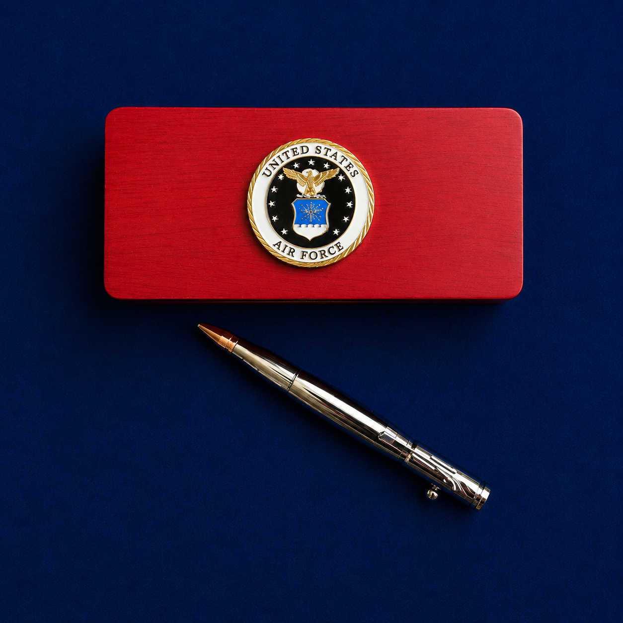 Red gift box set with U.S. Air Force emblem and pen on a blue background