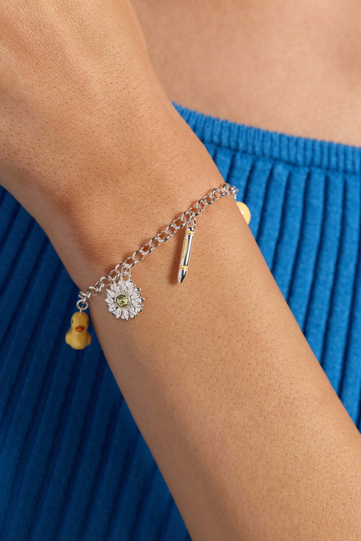 Crayola charm bracelet with duck sunflower bee worn on wrist, showcasing colorful charms and playful design.