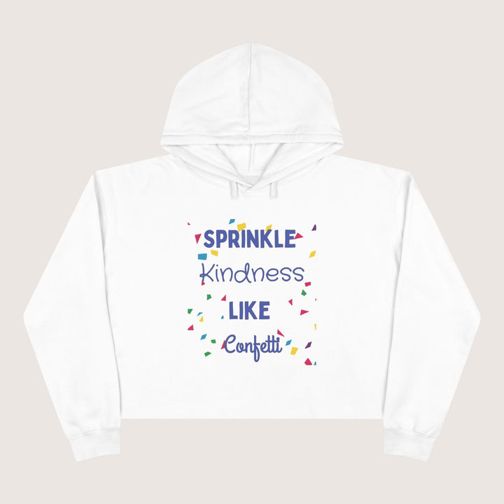 White hoodie with colorful text 'Sprinkle Kindness Like Confetti' on a beige background