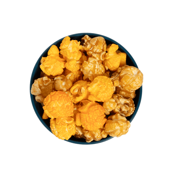 Bowl of Stevie G’s Gourmet Cheese Caramel Popcorn with fluffy orange kernels in teal bowl viewed from above