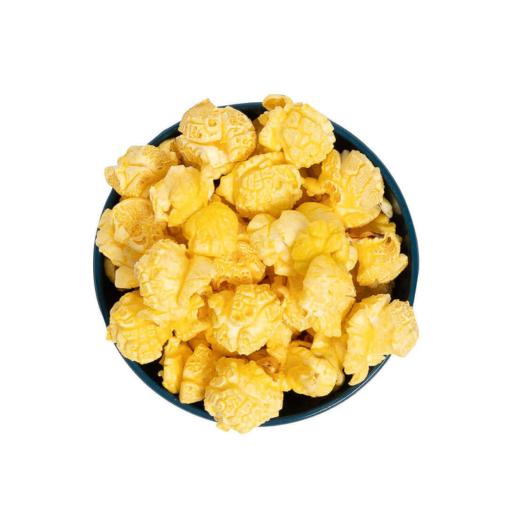 Bowl of Stevie G’s Gourmet Extra Buttery Popcorn with fluffy yellow kernels in teal bowl viewed from above