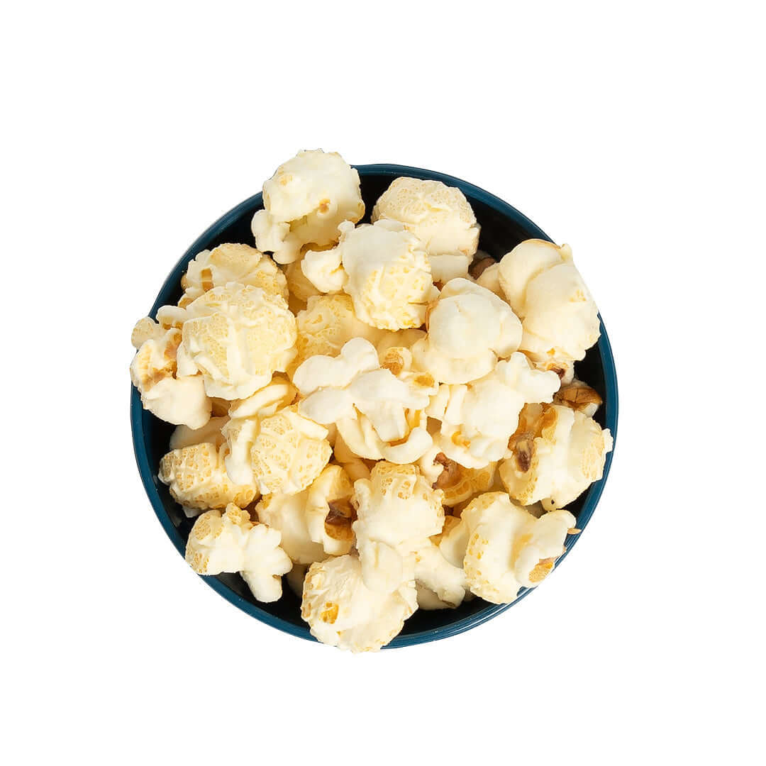 Bowl of Stevie G’s Gourmet White Cheddar Popcorn with fluffy white kernels in teal bowl viewed from above