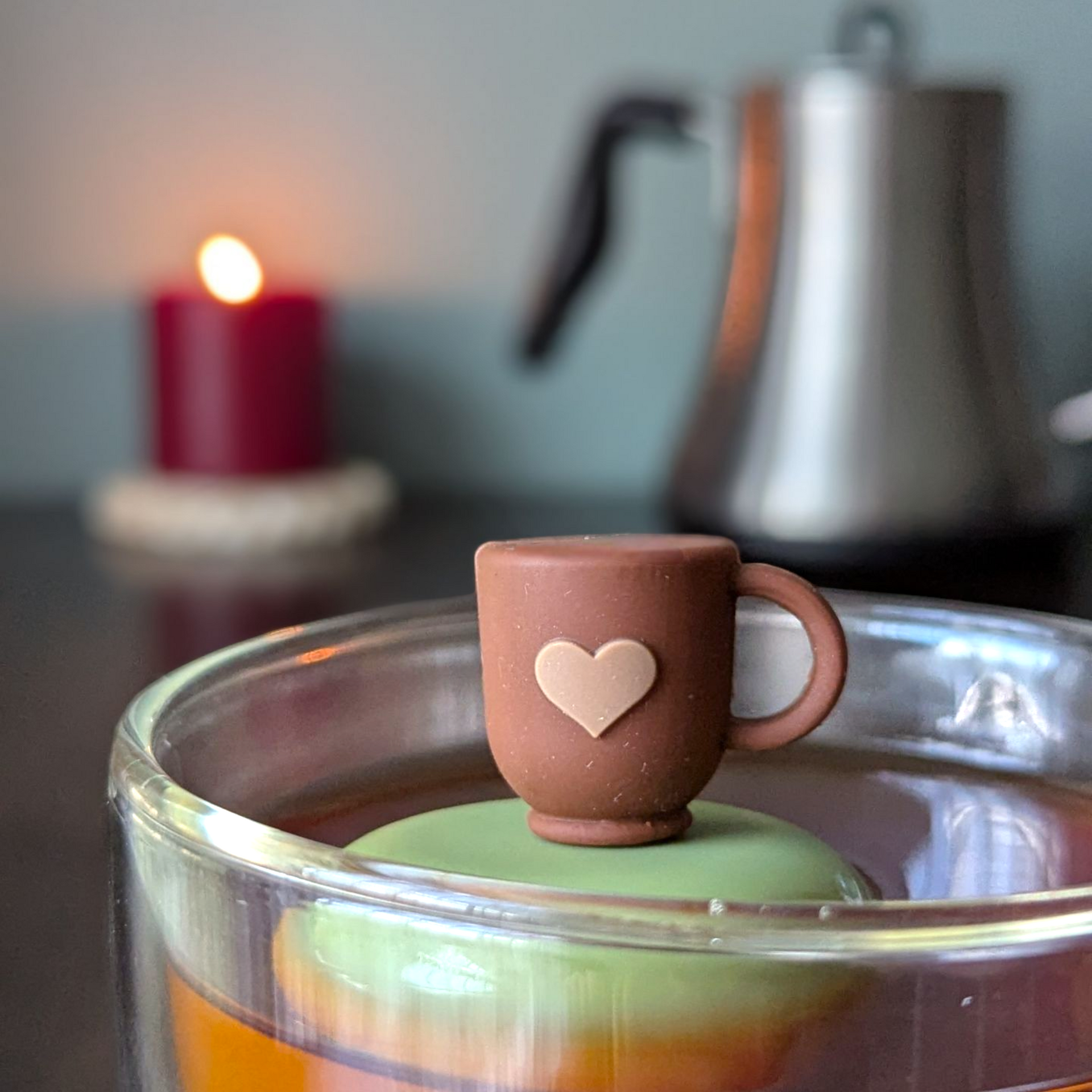 Floating Tea cup with heart tea infuser in a glass, perfect for brewing loose leaf tea.