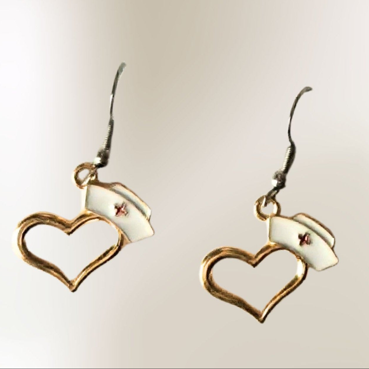 Gold heart nurse hat earrings with white nurse cap accents and hook backs by Jewelry by Sonya Lee