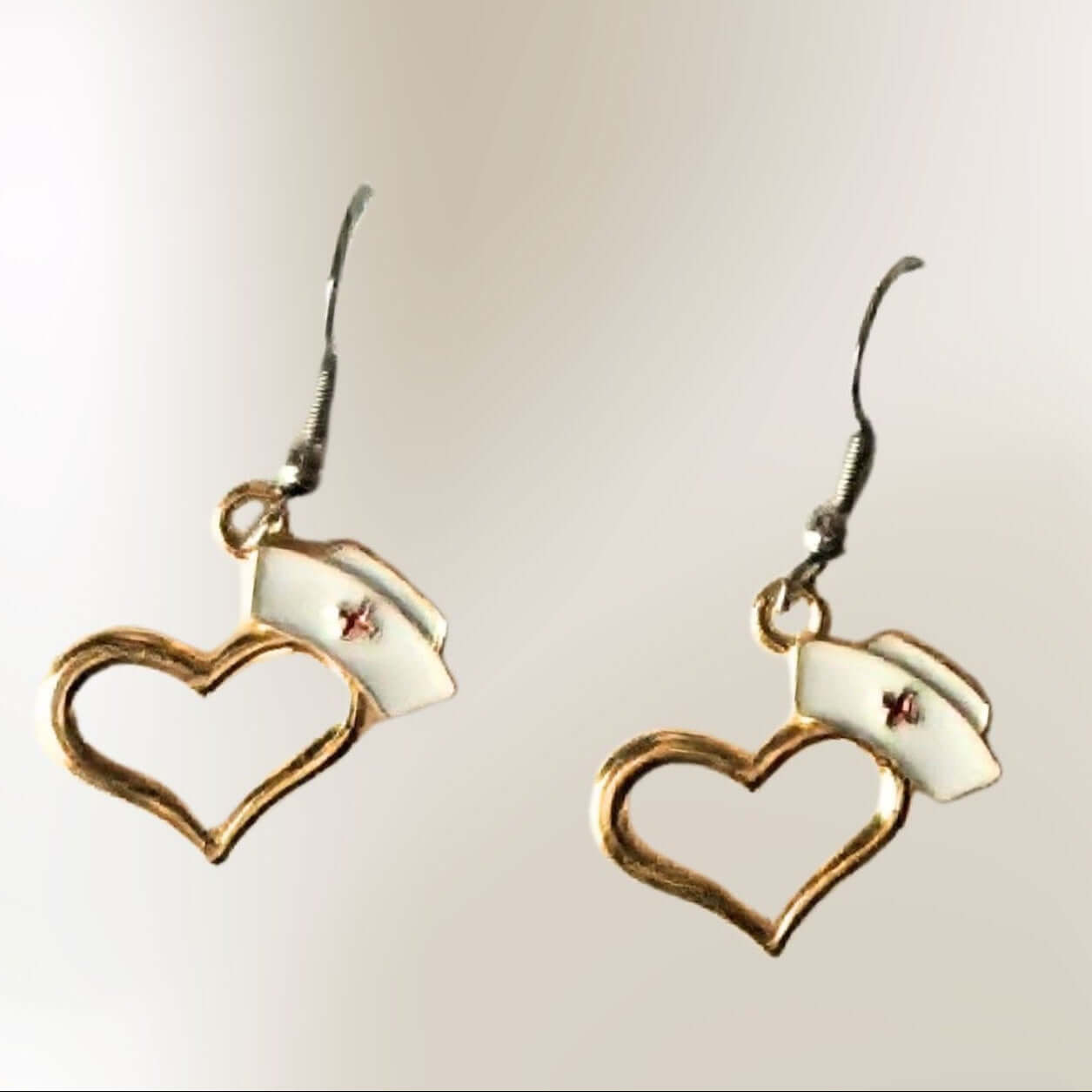 Gold heart nurse hat earrings with white nurse cap accents and hook backs by Jewelry by Sonya Lee