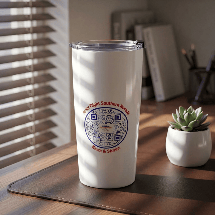 HFSN White tumbler with a QR logo on a wooden desk with a plant and blinds in the background