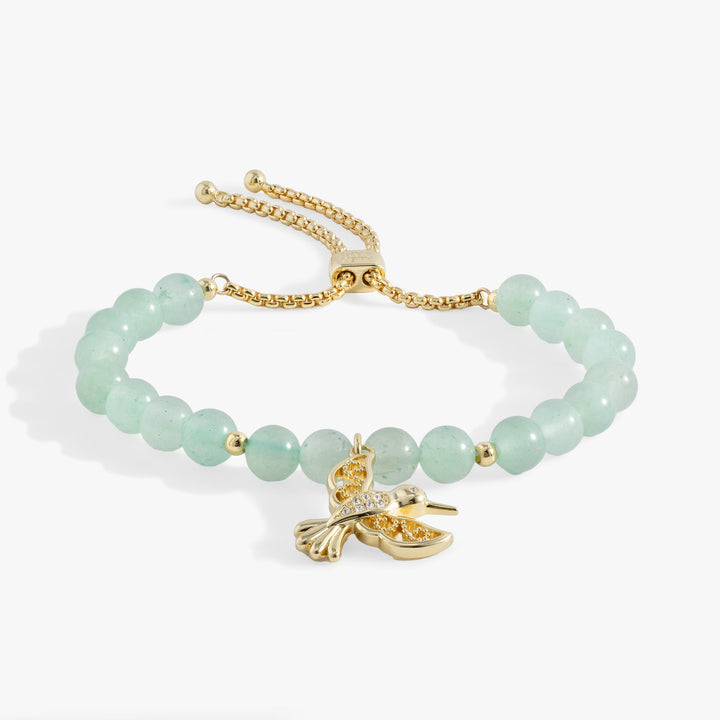 Hummingbird gemstone bolo bracelet featuring green aventurine beads and crystal-accented gold hummingbird charm