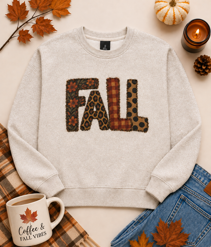 Cream patchwork FALL graphic sweatshirt featuring floral, plaid, leopard print and polka dot letters styled with cozy autumn decor.