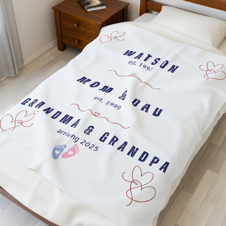 Personalized family timeline blanket with family name and established dates displayed on a bed
